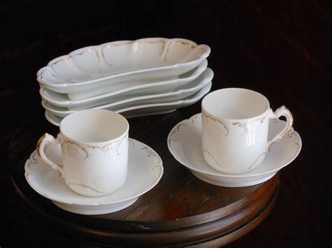 Two Limoges Demitasse Cups With Saucers And Four Half Moon Plates