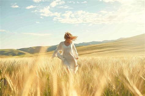 Premium Ai Image A Woman Running Through A Field Of Tall Grass