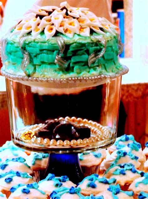 There Is A Cake And Cupcakes That Are On Top Of The Table Together