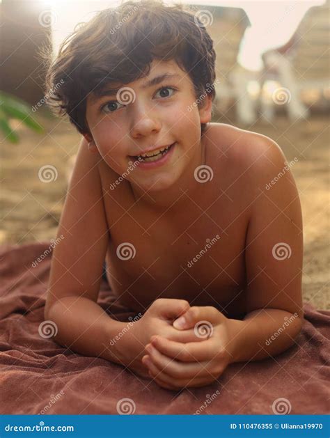 Teenager Boy With Brown Tan Having Sun Bath On The Beach Stock Image
