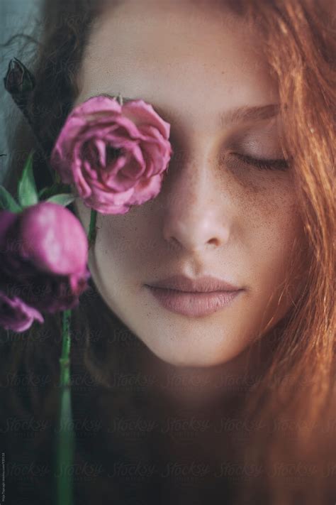 Portrait Of A Beautiful Redhead With Freckles Holding A Rose By Maja