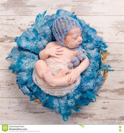 Peacefully Sleeping Newborn In Basket With Blue Blanket Stock Photo