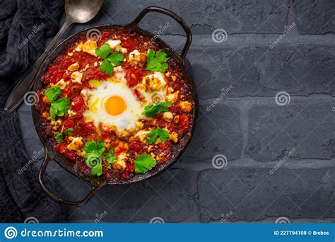 Shakshouka Dish Of Eggs Poached In A Sauce Of Tomatoes Olive Oil