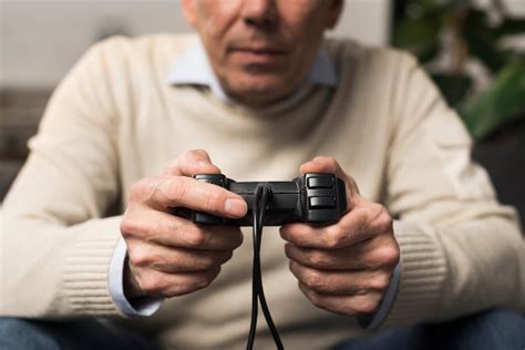 Free Photo Close Up Old Man Holding Controller