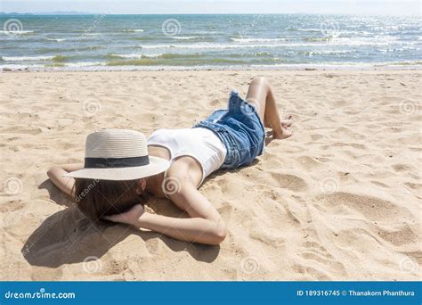 A Woman Is Laying On The Beach Stock Image Image Of Resting Copy 189316745