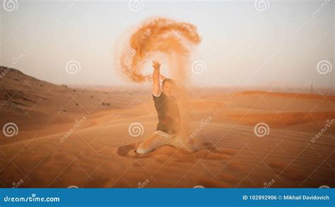 The Guy Throws Sand Over Himself In The Desert The Desert Is Next To