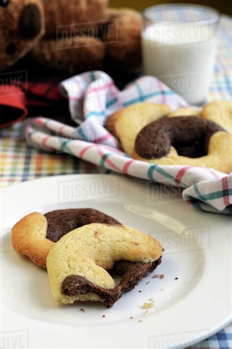 Chocolate And Vanilla Biscuits And A Glass Of Milk Stock Photo Dissolve