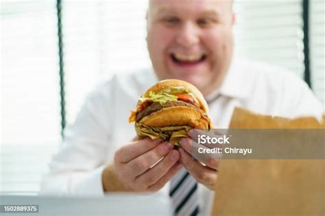 Fat Man Eating Cheeseburger Stock Photo Download Image Now Eating