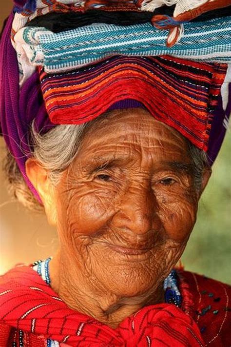 An Old Woman Wearing A Colorful Head Piece