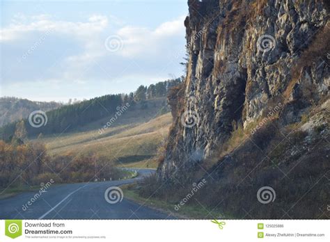 The Road Is Along A Steep Cliff Mountain Altai Russia Stock Photo