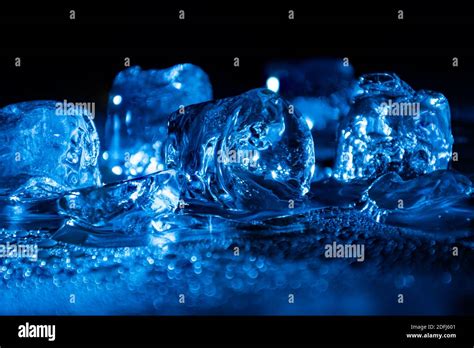 Melting Frozen Ice Cubes Illuminated With Blue Coloured Led Light In