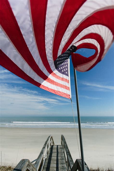 American Flag Waving On Pole At Beach In Summer By Stocksy