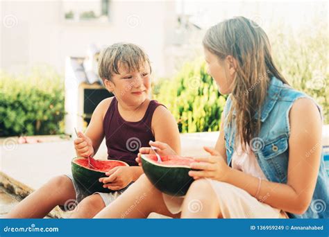 Outdoor Summer Portrait Of Two Funny Kids Eating Watermelon Stock Image