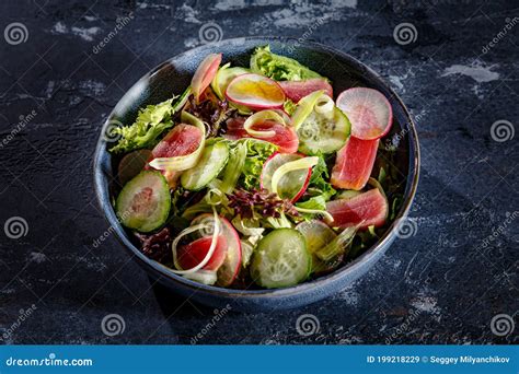 Salad Of Lettuce Tuna Cucumbers And Radishes Is On The Plate Stock