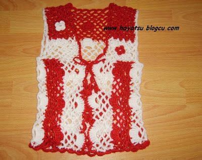 A Red And White Crocheted Vest With Hearts On The Collar Attached To A