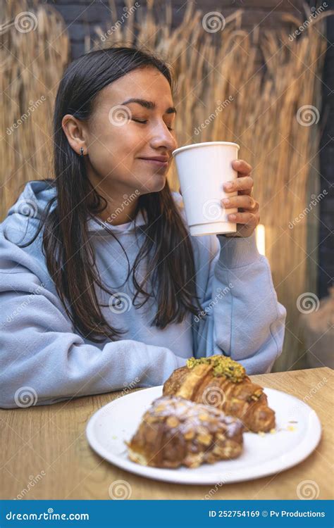 A Young Woman Eats Croissants With Coffee In A Cafe Stock Image Image Of Girl Sweet 252754169