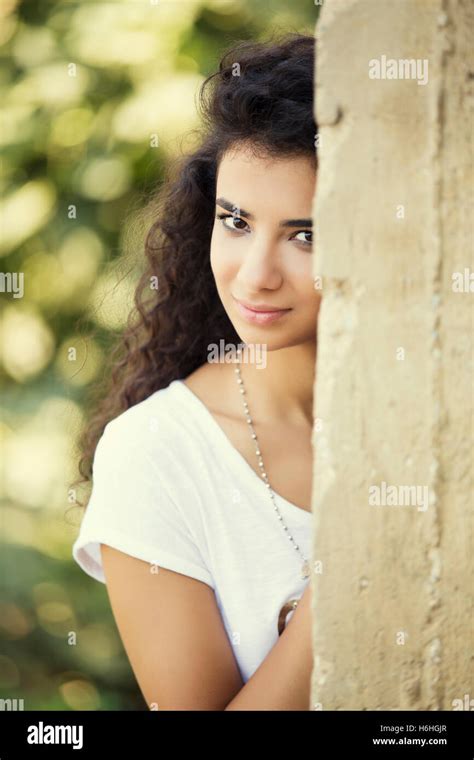 Beautiful Girl Leaning Against The Wall Smiling Stock Photo Alamy