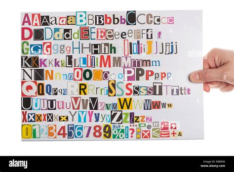 Hand Holding Newspaper Clippings Alphabet With Letters Numbers And