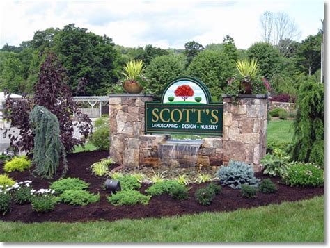 The Sign For Scotts Landscaping And Garden Nursery In Front Of Some
