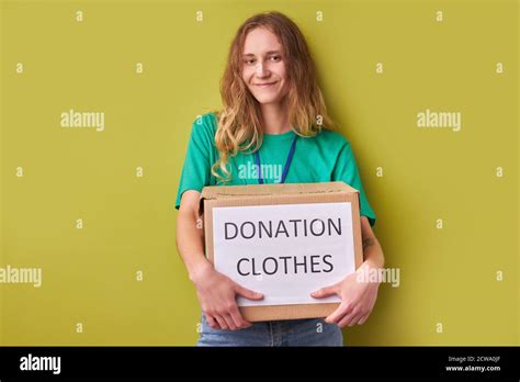 Young Caucasian Woman Holding A Donate Box With Clothes Charity
