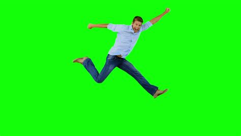 Man Jumping And Gesturing On Green Screen In Slow Motion Stock Footage