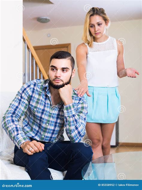 Adult Asking Offended Partner For Forgiveness At Home Stock Photo