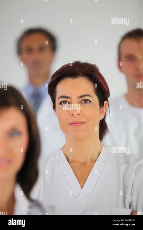 Nurse Standing With Colleagues Stock Photo Alamy