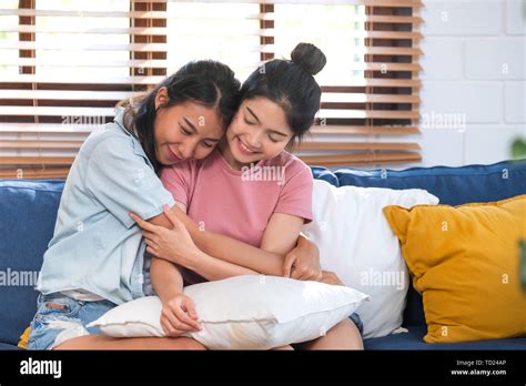 Happy Asian Lesbian Couple Hug Each Other With Love On Sofa At Living Room At Homelgbtq