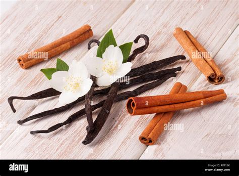 Vanilla Sticks And Cinnamon With Flower And Leaf On A White Wooden