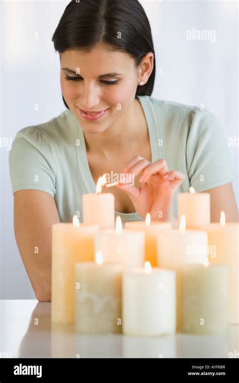 Woman Lighting Candles Stock Photo Alamy