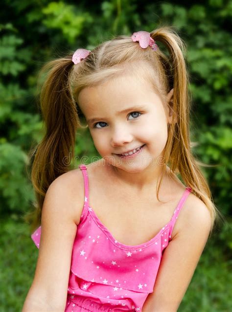 Outdoor Portrait Of Smiling Little Girl Stock Photo
