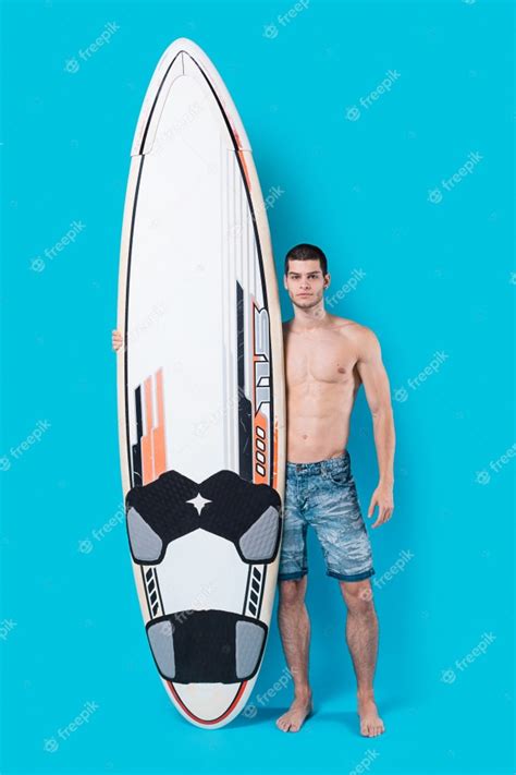 Free Photo Confident Surfer Holding A Surfboard