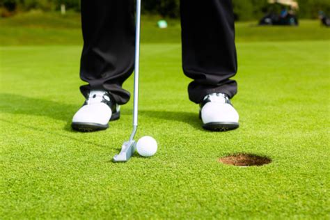 Golf Player Putting Ball In Hole Stock Photo Download Image Now Istock