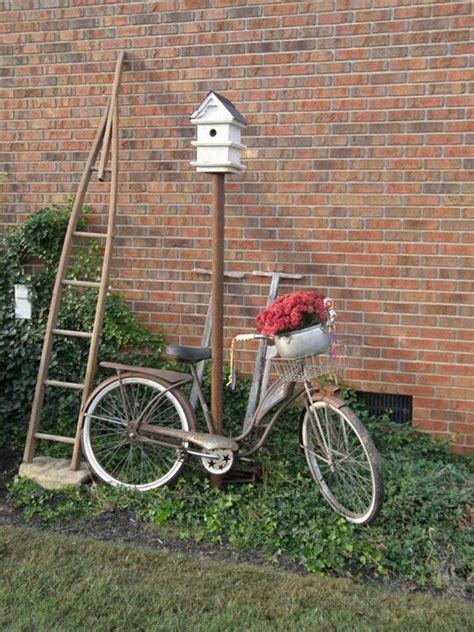 A Bicycle Parked Next To A Brick Wall With A Bird House On The Back Tire