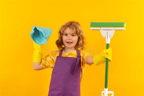 Child Doing Housework Studio Portrait Of Child Use Duster And Gloves