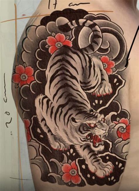 A Man With A Tiger Tattoo On His Back