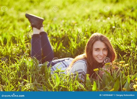 Young Beautiful Redhead Woman Sits On A Green Meadow Looking At Camera Stock Image Image Of
