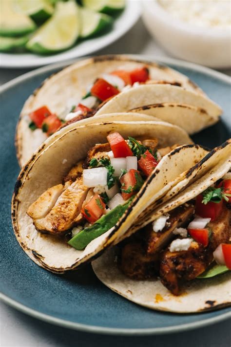 Marinated grilled chicken with a homemade street corn salsa, fresh avocado, cotija cheese, and spiced mexican crema. Chicken Street Tacos | Our Salty Kitchen