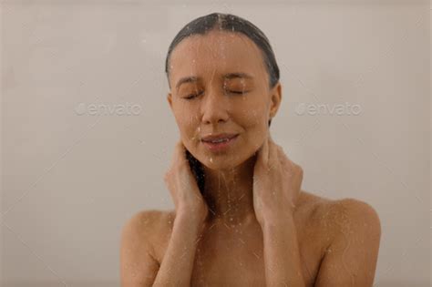 Young Woman Under The Trickles Of Water In Pleasure Shower Beautiful