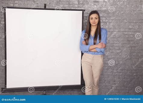 Business Woman Stands Next To A White Background Copy Space Stock