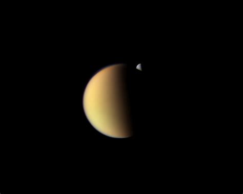 Rhea Behind Titan The Planetary Society