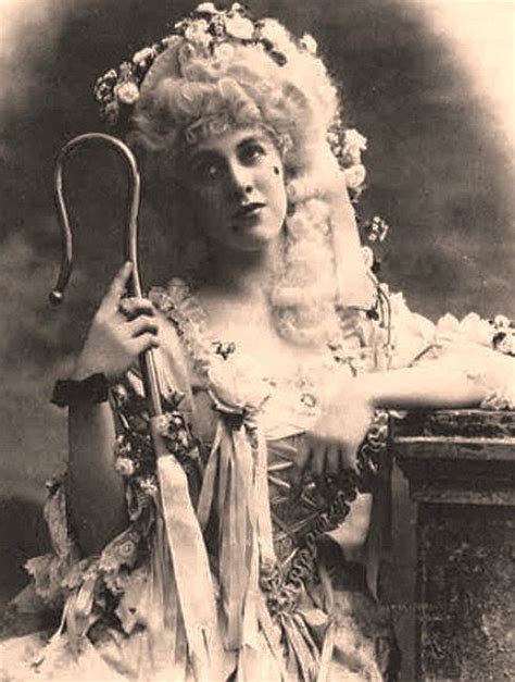 An Old Black And White Photo Of A Woman In Costume