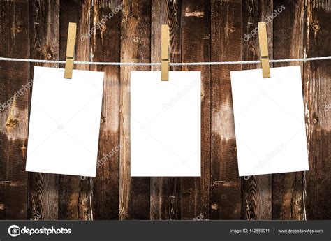 Photo Frames With Pins On Rope Over Old Aged Wood Wall Background Stock