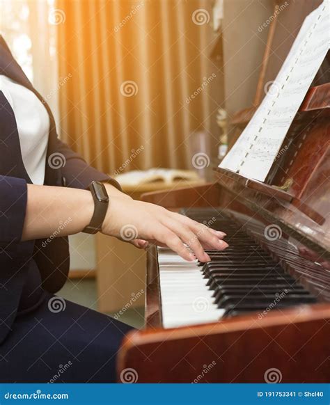Young Woman Playing The Piano On Sheets In The Music Room In The Early