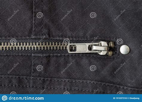 Closed Brass Zip On Black Jeans Texture Background Close Up View Stock
