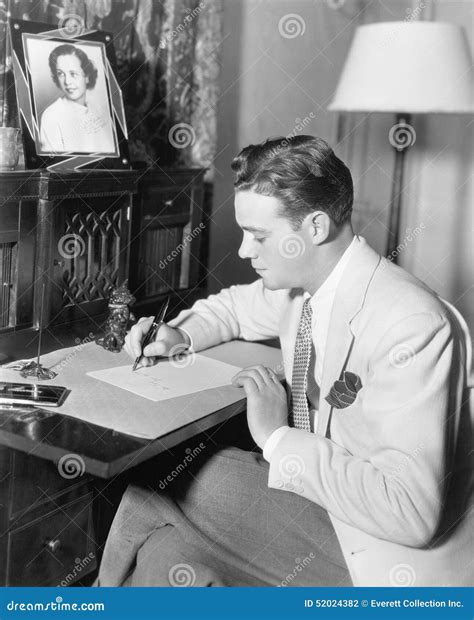 Man Sitting At His Desk Writing A Letter With A Fountain Pen Stock