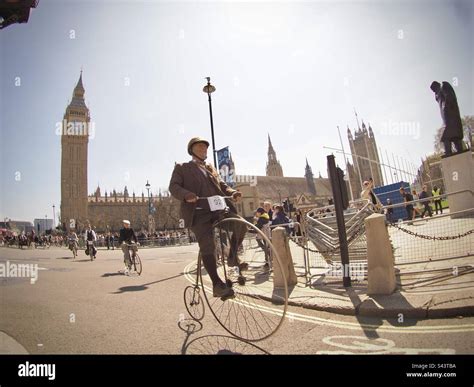 Penny Farthing Rider In Front Of Big Ben And The Houses Of Parliament London Tweed Run 2023