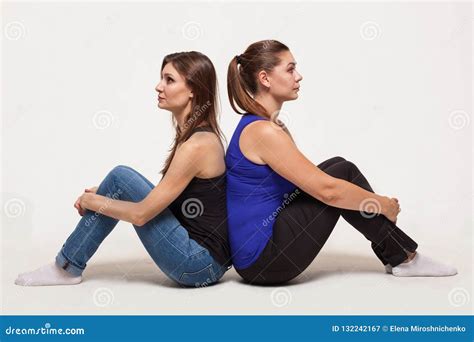 Two Attractive Women Sit Back To Back Stock Image Image Of Couple