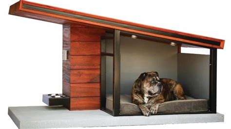 A Dog Laying On Top Of A Bed In A Small Wooden Structure With Doors Open