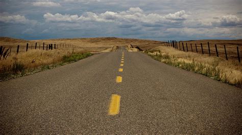 Empty Two Lane Highway By Erik Lykins